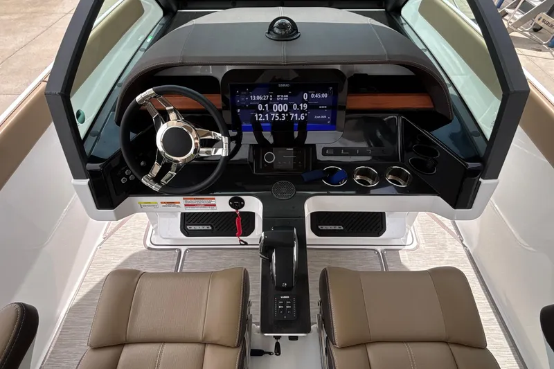 Slide: The Image of Cockpit of 2026 Monterey Elite 27 OB boat with modern steering and digital display. - 55