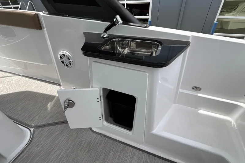 Slide: The Image of 2026 Monterey Elite 27 OB boat interior with sink and storage compartment. - 56