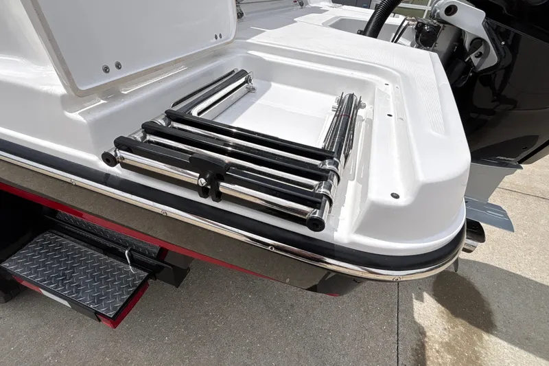 Slide: The Image of 2026 Monterey Elite 27 OB boat with foldable swim ladder on deck. - 59