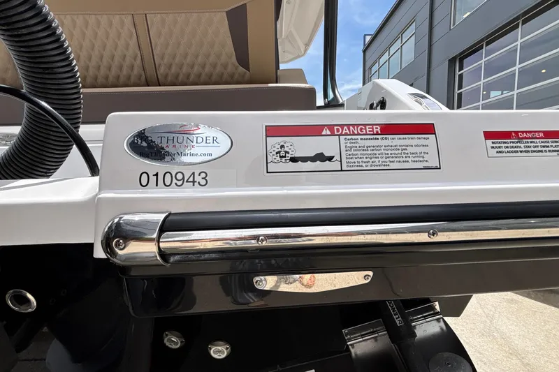 Slide: The Image of 2026 Monterey Elite 27 OB boat stern with safety warnings and Big Thunder Marine label. - 60