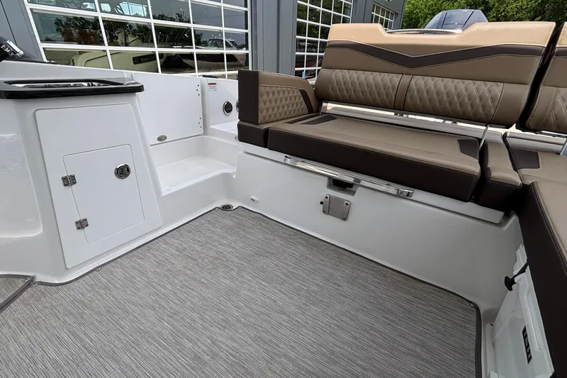 Slide: The Image of Interior of 2026 Monterey Elite 27 OB boat with cushioned seating and storage. - 8