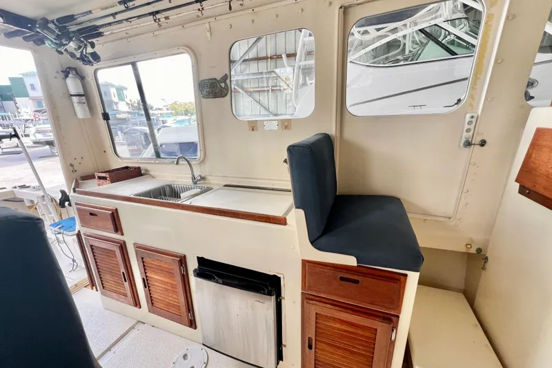 Slide: The Image of 2001 Rosborough RF-246 Sedan Cruiser interior with kitchenette and seating area. - 11