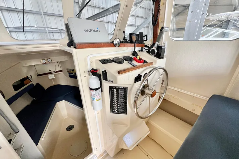 Slide: The Image of 2001 Rosborough RF-246 Sedan Cruiser helm with Garmin navigation and steering wheel. - 13