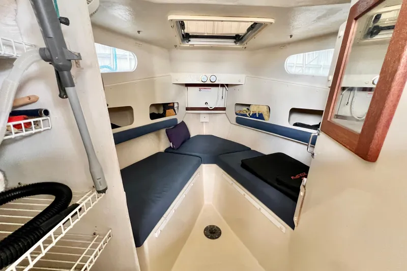 Slide: The Image of 2001 Rosborough RF-246 Sedan Cruiser cabin interior with seating and storage shelves. - 14