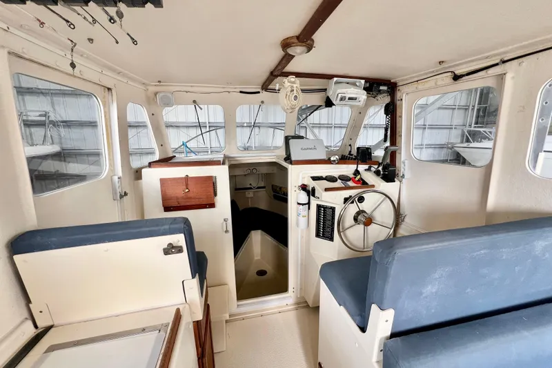 Slide: The Image of 2001 Rosborough RF-246 Sedan Cruiser interior with helm, seating, and navigation equipment. - 15