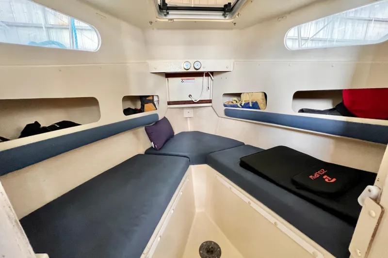 Slide: The Image of Interior of 2001 Rosborough RF-246 Sedan Cruiser with cushioned seating and storage compartments. - 16