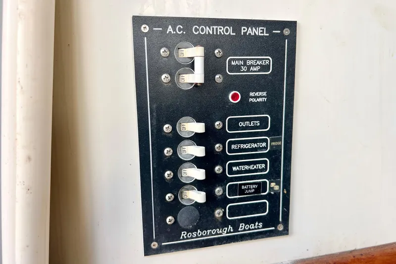 Slide: The Image of AC control panel on 2001 Rosborough RF-246 Sedan Cruiser, featuring main breaker and switches. - 17