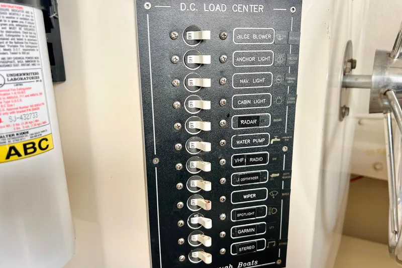 Slide: The Image of DC load center panel on 2001 Rosborough RF-246 Sedan Cruiser, featuring various switches. - 19