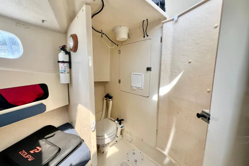 Slide: The Image of 2001 Rosborough RF-246 Sedan Cruiser interior with toilet and fire extinguisher. - 21