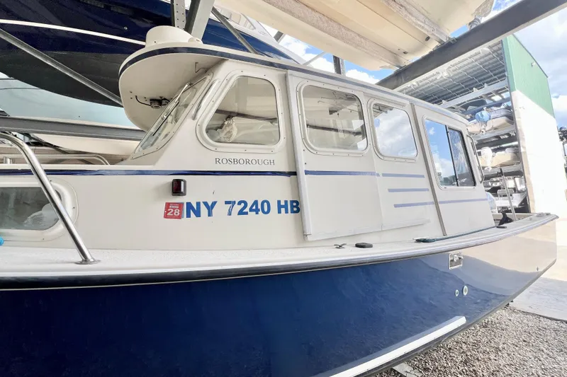 Slide: The Image of 2001 Rosborough RF-246 Sedan Cruiser docked, displaying registration NY 7240 HB. - 3