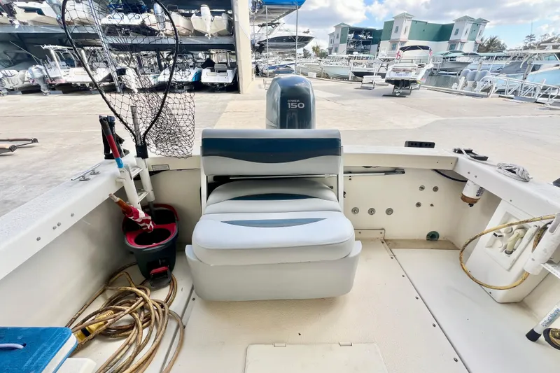 Slide: The Image of 2001 Rosborough RF-246 Sedan Cruiser interior with seating, fishing gear, and Yamaha 150 engine. - 6