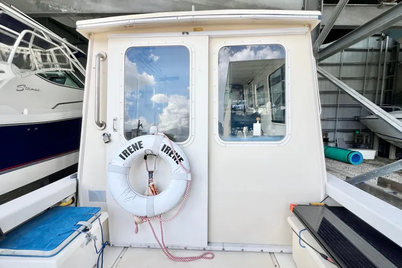 Slide: The Image of 2001 Rosborough RF-246 Sedan Cruiser with life preserver, docked in a marina. - 7