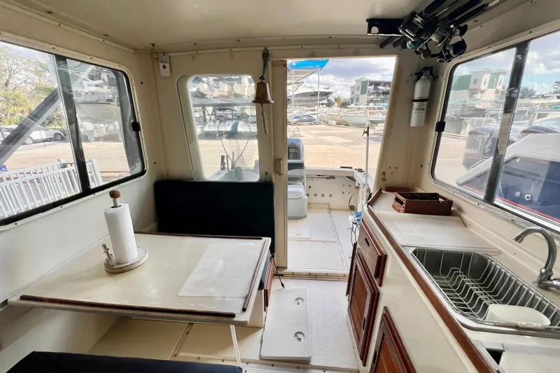 Slide: The Image of Interior of 2001 Rosborough RF-246 Sedan Cruiser with table, sink, and seating. - 8