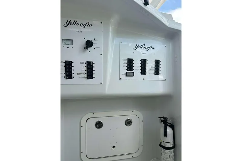 Slide: The Image of Control panel of a 2014 Yellowfin 42 Offshore boat with electrical switches and fire extinguisher. - 19