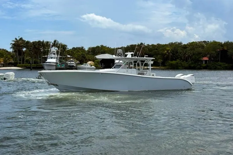 Slide: The Image of 2014 Yellowfin 42 Offshore boat cruising on a calm waterway. - 23