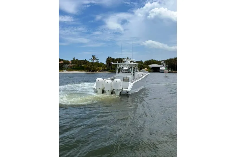 Slide: The Image of 2014 Yellowfin 42 Offshore boat cruising on a scenic waterway. - 24