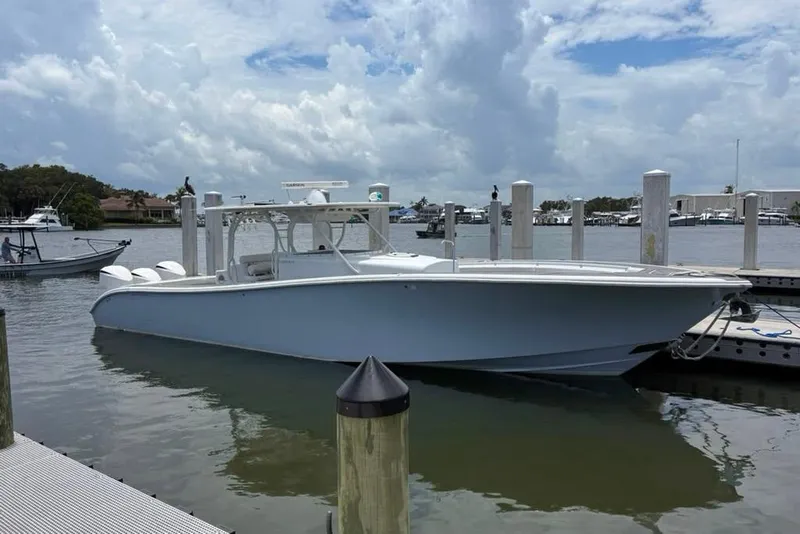 Slide: The Image of 2014 Yellowfin 42 Offshore boat docked at marina under cloudy sky. - 26