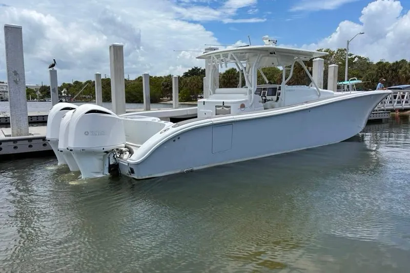Slide: The Image of 2014 Yellowfin 42 Offshore boat docked, featuring dual outboard engines. - 29