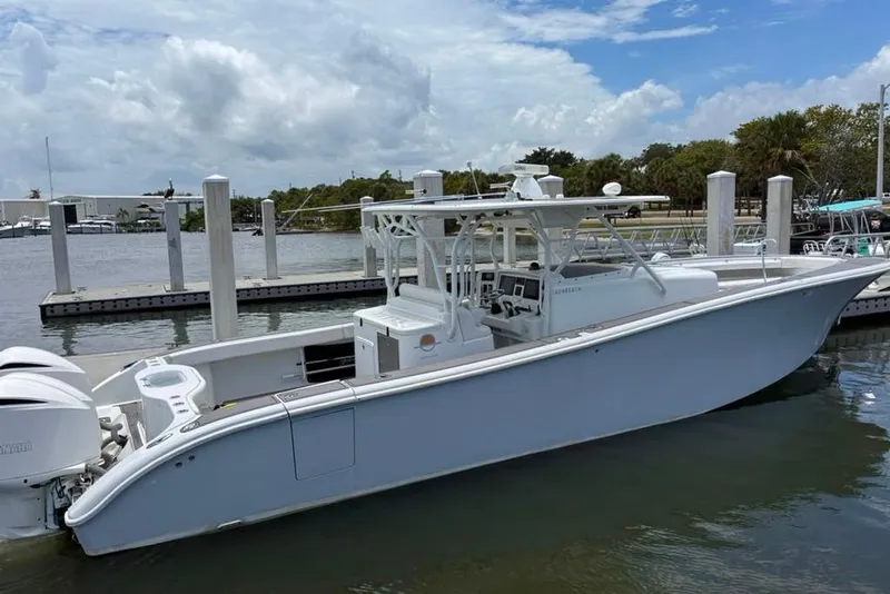 Slide: The Image of 2014 Yellowfin 42 Offshore boat docked at marina under cloudy sky. - 30