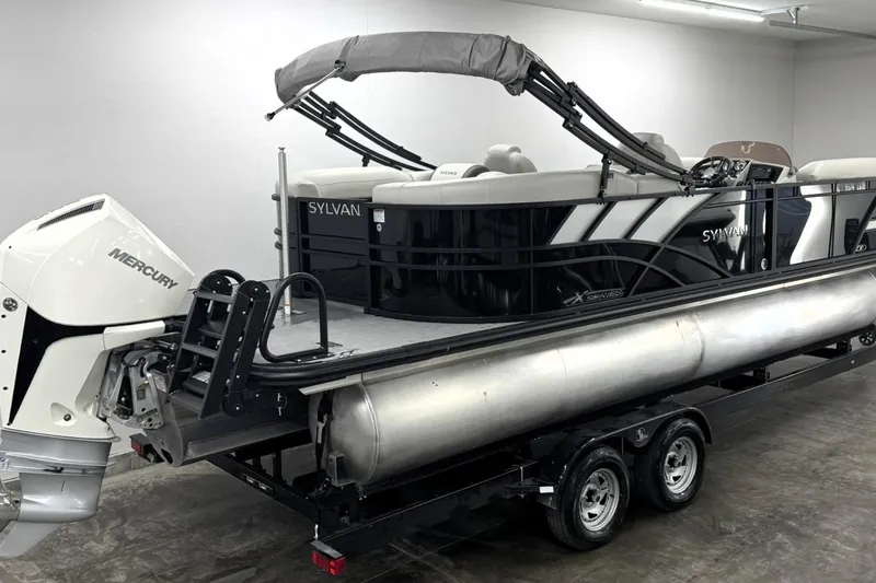 Slide: The Image of 2025 Sylvan Mirage X X5 pontoon boat on trailer with Mercury outboard engine. - 1