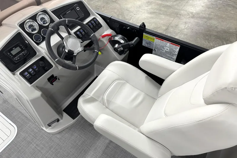 Slide: The Image of Interior view of 2025 Sylvan Mirage X X5 boat cockpit with steering wheel and controls. - 19