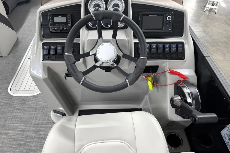 Slide: The Image of 2025 Sylvan Mirage X X5 boat dashboard with steering wheel and control panel. - 20