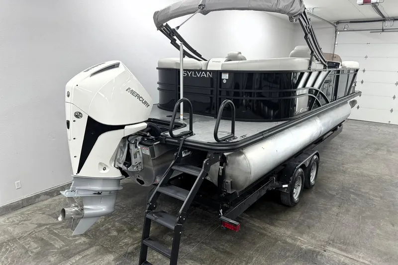 Slide: The Image of 2025 Sylvan Mirage X X5 pontoon boat with Mercury outboard motor on trailer. - 7