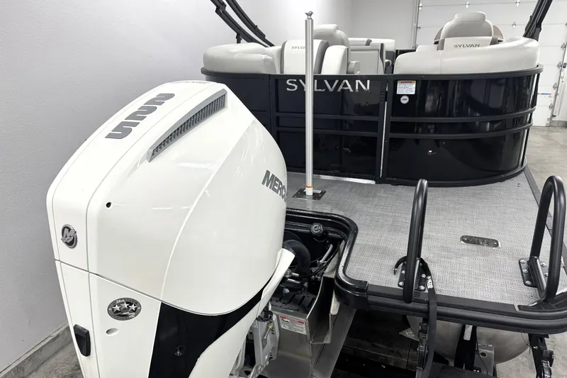 Slide: The Image of 2025 Sylvan Mirage X X5 pontoon boat with Mercury outboard motor in a showroom. - 8