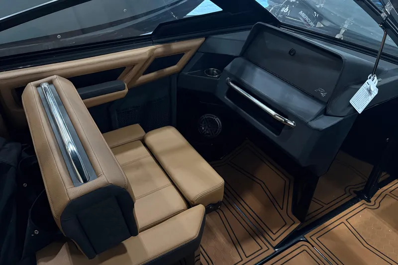 Slide: The Image of 2026 Cobalt R4 Surf boat interior with tan leather seating and sleek dashboard design. - 14