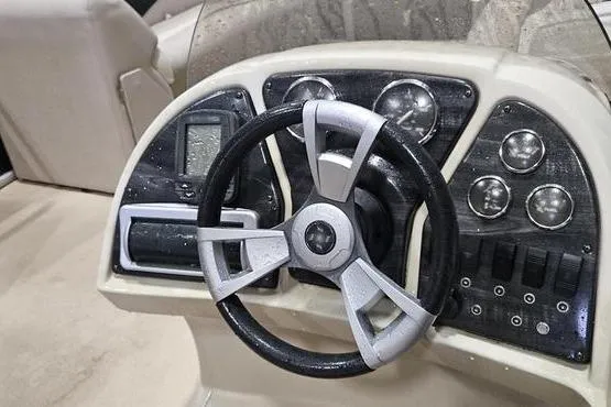 Slide: The Image of Steering console of 2013 Sweetwater SW 2286 boat with gauges and controls. - 2