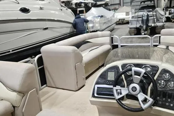 Slide: The Image of 2013 Sweetwater SW 2286 pontoon boat interior with steering console and seating. - 4