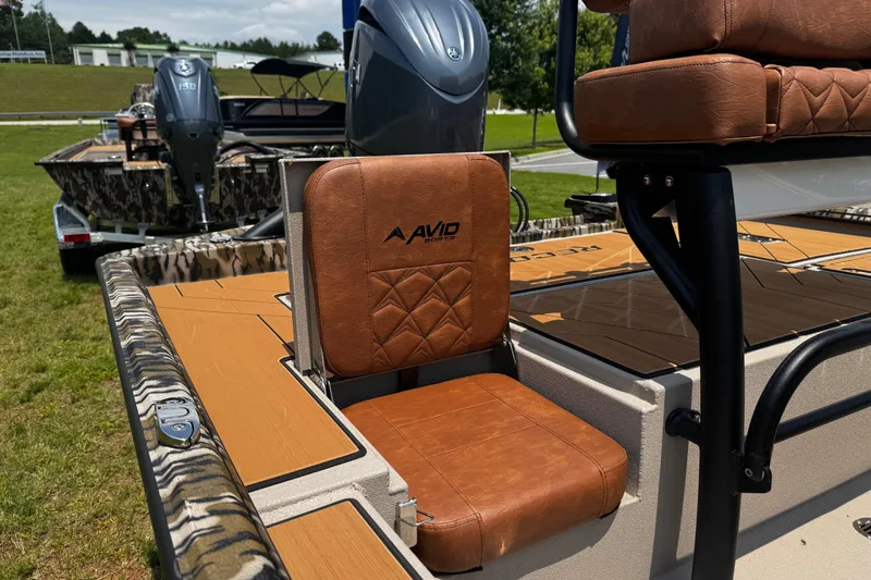 Slide: The Image of 2026 Avid 207 Recon boat with brown leather seating and camouflage detailing. - 10