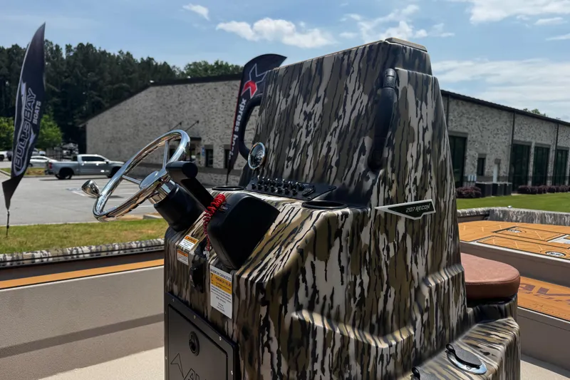 Slide: The Image of Camouflage-patterned console of 2026 Avid 207 Recon boat with steering wheel outdoors. - 11