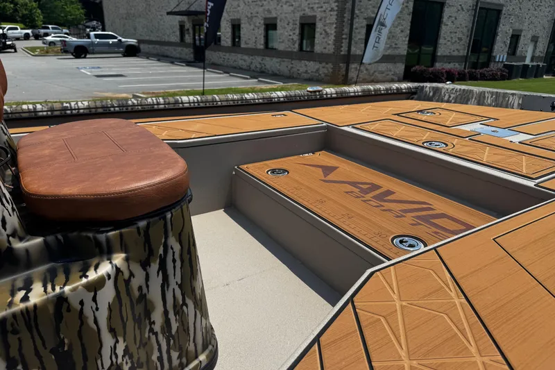 Slide: The Image of 2026 Avid 207 Recon boat interior with camo design and brown leather seating. - 15