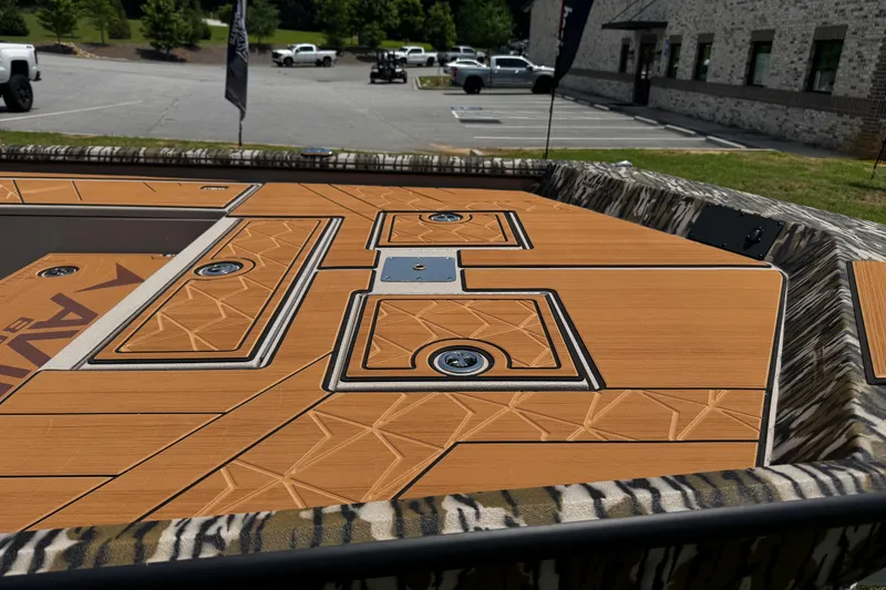 Slide: The Image of Avid 207 Recon 2026 boat deck with intricate wood pattern and camouflage trim. - 17