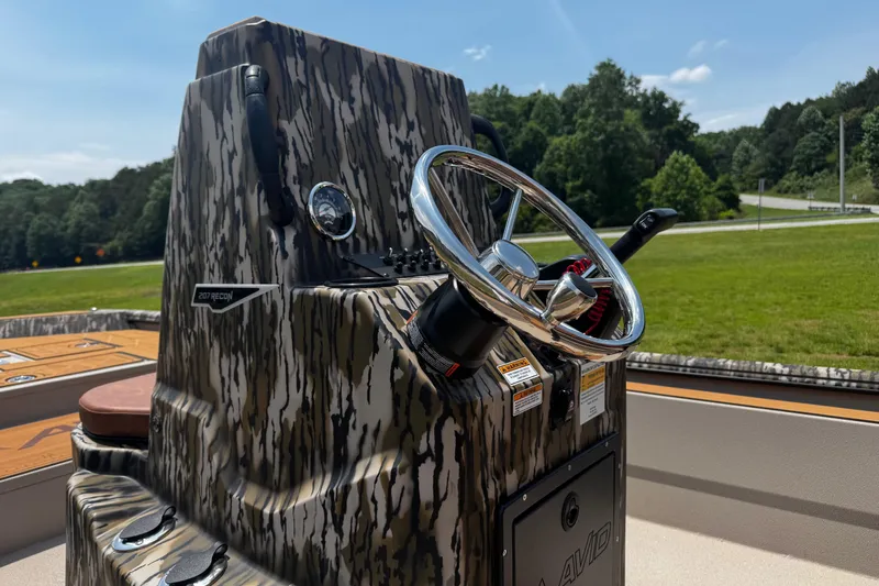 Slide: The Image of Steering console of 2026 Avid 207 Recon boat with camouflage design. - 2