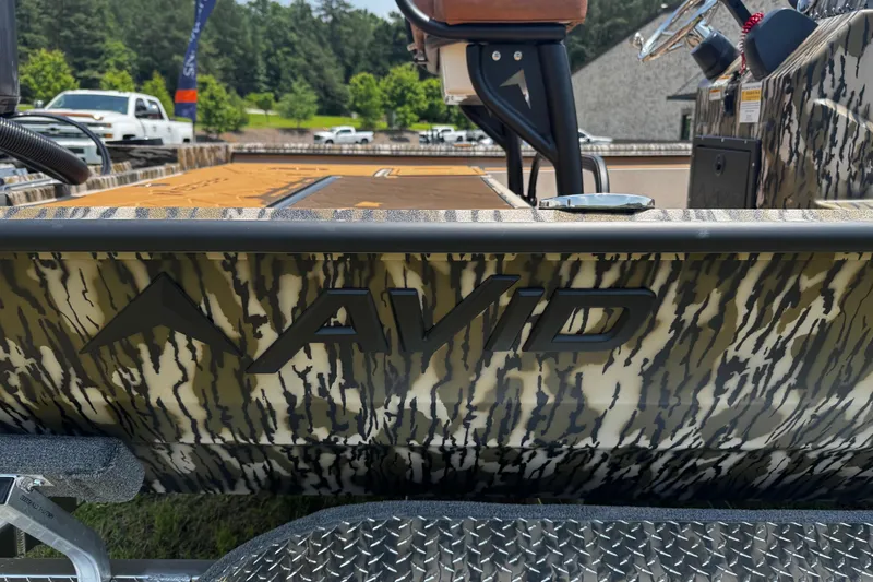Slide: The Image of Avid 207 Recon 2026 boat with camouflage design, parked outdoors. - 20