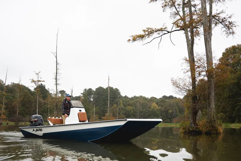 Slide: The Image of Manufacturer Provided Image: 2026 Avid 207 Recon boat navigating a serene, tree-lined waterway. - 27