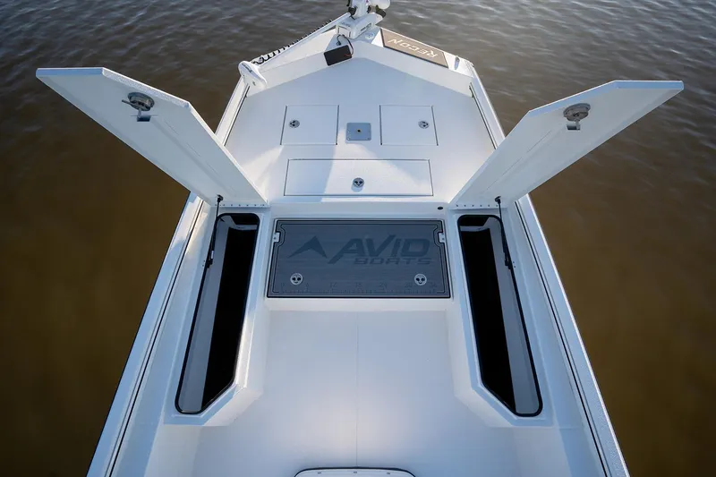 Slide: The Image of Manufacturer Provided Image: Avid 207 Recon 2026 boat deck with open storage compartments on calm water. - 29