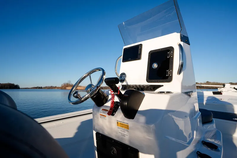 Slide: The Image of Manufacturer Provided Image: Avid 207 Recon 2026 boat console with steering wheel on a calm lake. - 31