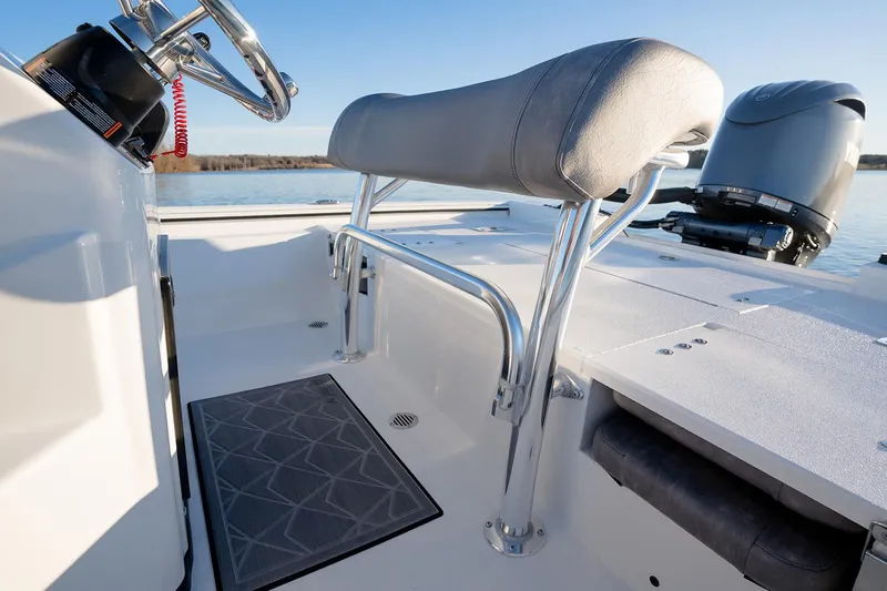 Slide: The Image of Manufacturer Provided Image: Avid 207 Recon 2026 boat interior with steering wheel and seating, on calm water. - 32