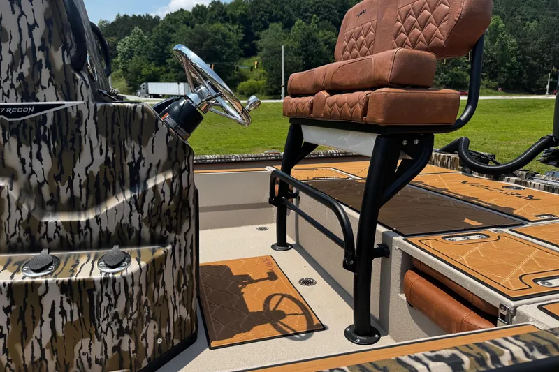 Slide: The Image of 2026 Avid 207 Recon boat interior with camo design and brown seating. - 4