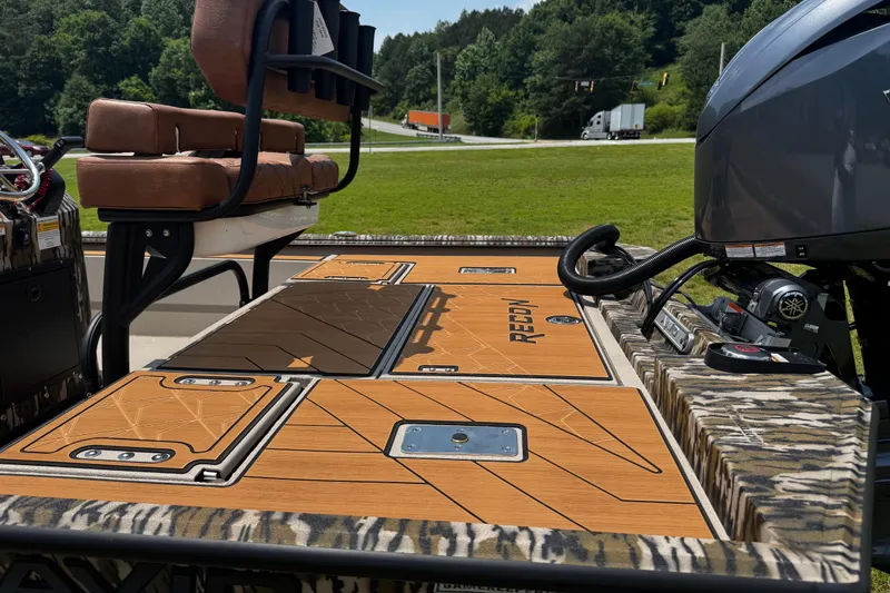 Slide: The Image of 2026 Avid 207 Recon boat deck with camo pattern and seating, outdoors. - 5
