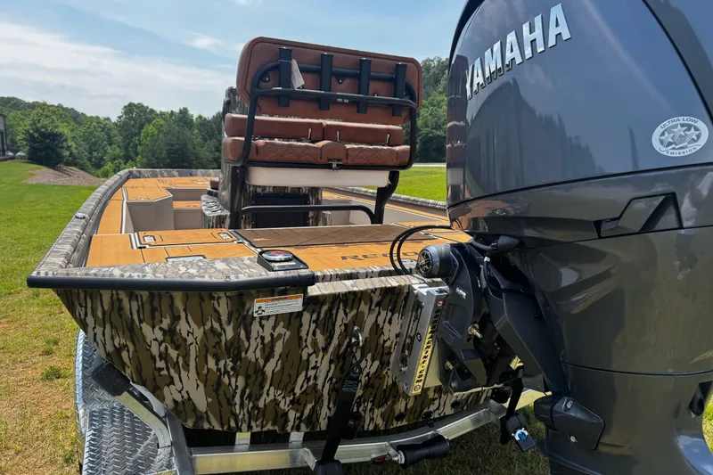 Slide: The Image of Avid 207 Recon boat with Yamaha engine, camo design, and brown seating, 2026 model. - 6