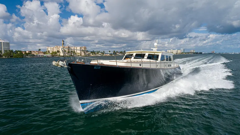 Slide: The Image of Vicem 85 Classic yacht cruising on open water, 2006 model, under a partly cloudy sky. - 3