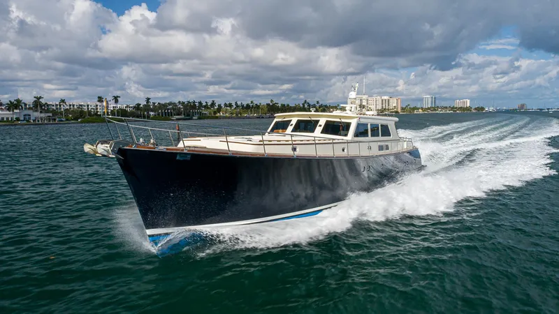 Slide: The Image of 2006 Vicem 85 Classic yacht cruising on open water under a partly cloudy sky. - 4