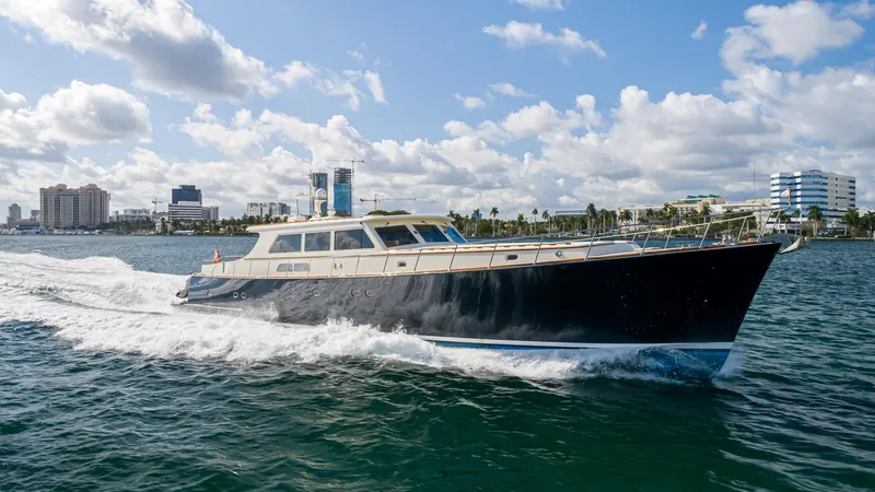 Slide: The Image of 2006 Vicem 85 Classic yacht cruising on water with city skyline in background. - 5