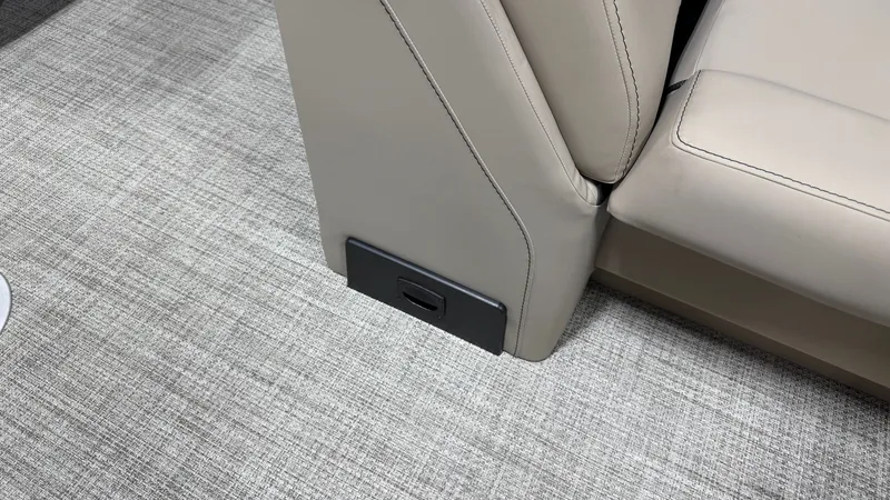 Slide: The Image of Close-up of a seating area with beige upholstery and gray carpet flooring. - 31