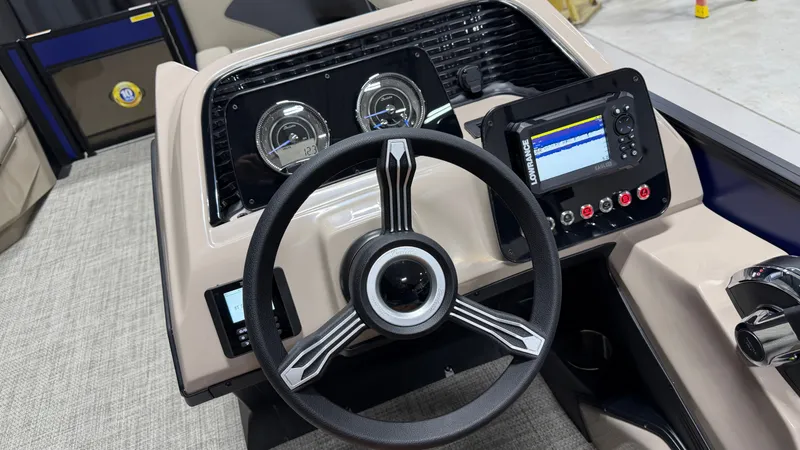 Slide: The Image of The image shows the helm of a Barletta ARIA22UC boat with modern gauges and a display screen. - 49