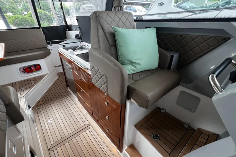 Slide: The Image of Luxurious interior of 2024 Aquador 300 HT boat with elegant seating and wood finishes. - 19